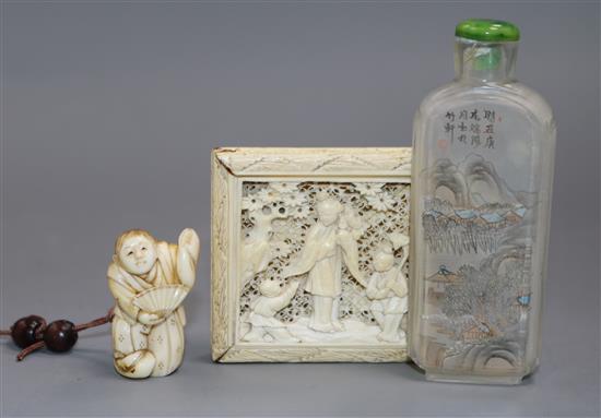 A Chinese ivory tangram puzzle, an ivory netsuke and a pressed amber rhino